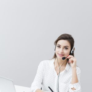 front-view-woman-wearing-headset-working-desk-with-laptop